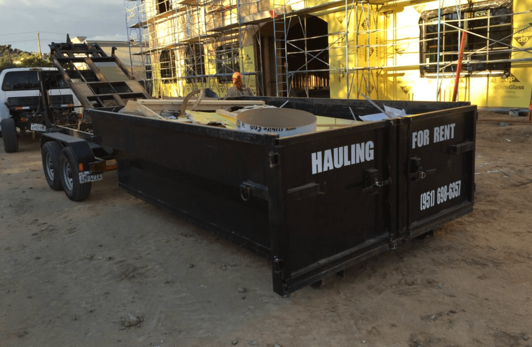 Maximum Cleaning hauling dumpster at a construction cleanup site